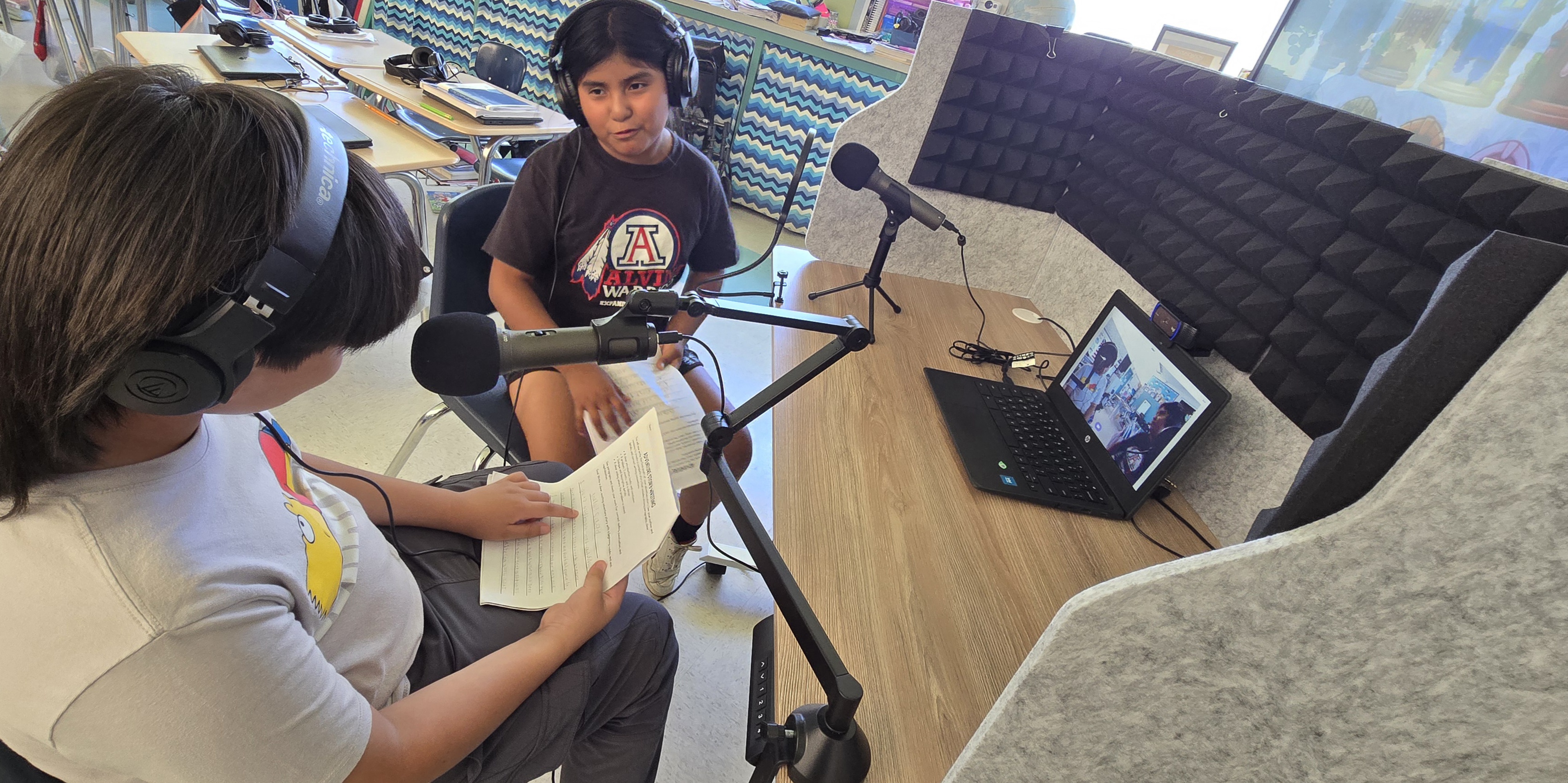 students on radio mics, interviewing each other