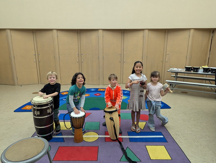 young children playing musical instruments 