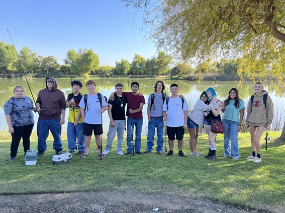 High school students fishing at a pond