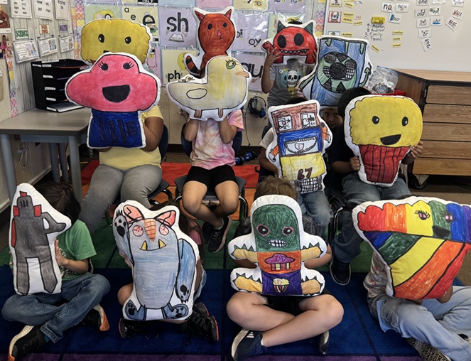 Children holding up stuffed animal toys