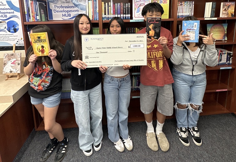 students holding up books