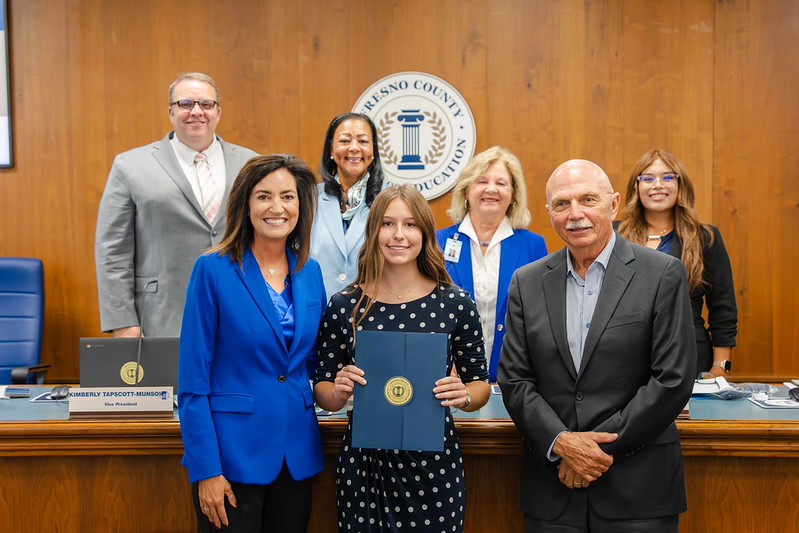 Student recognized as the Superintendent's Superstar standing with Superintendent of Schools, board of education, and donor of the $500 award.